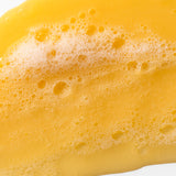 Close-up of Banana Truly Nourishing Shampoo 250 ML highlighting rich texture on white background.
