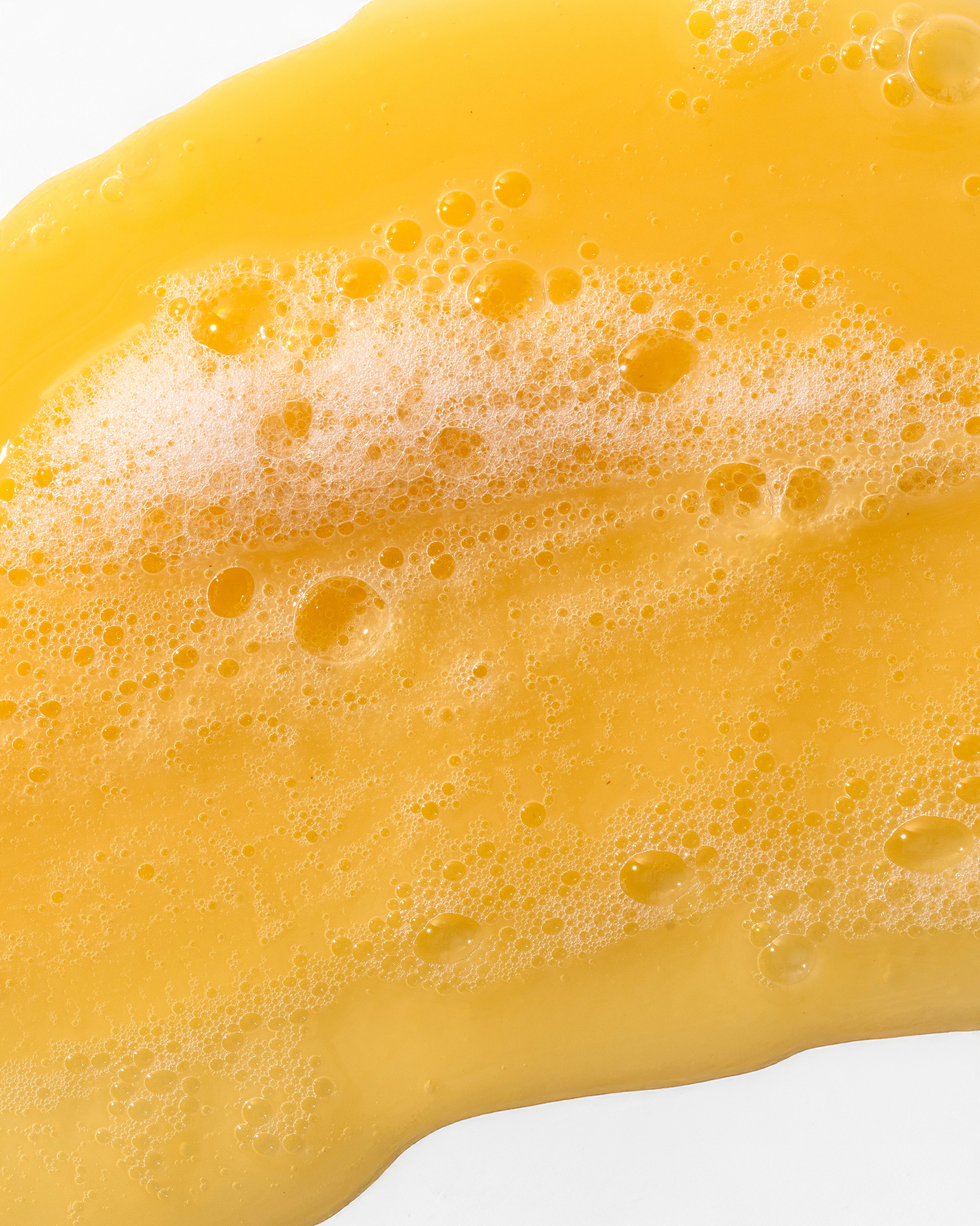 Close-up of Banana Truly Nourishing Shampoo 250 ML highlighting rich texture on white background.