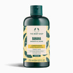 A bottle of The Body Shop Banana Smooth & Shine Conditioner 250ml against a clean background.