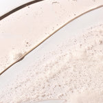 Close-up of ginger scalp care shampoo 250ml displaying bubbly texture against a clean background.