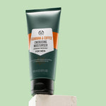 Guarana & Coffee Energising Moisturiser For Men 100 ML on white block against green background