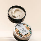 The Body Shop Shea Body Butter 200 ML against a clean minimal backdrop, highlighting creamy texture and vibrant packaging.