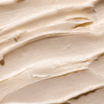 Close-up of creamy Shea Body Butter, showcasing its smooth texture