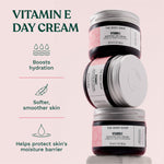 Three jars of The Body Shop Vitamin E Day Cream on a light pink background with text about product benefits. Boosts hydration. Softer, smoother skin. Helps protect skin's moisture barrier.